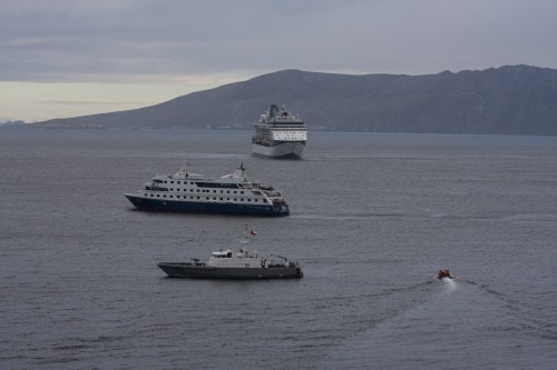 A large passenger liner approaches our small boat