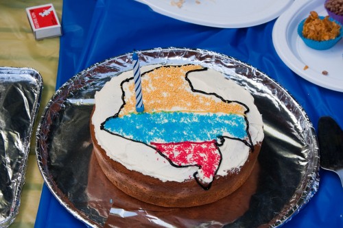 Andres's birthday cake - map of Colombia (in Colombian flag colours) with a candle marking approximately where Cali is